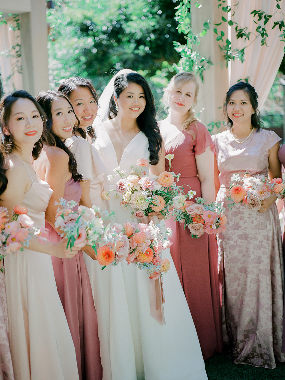 pink bridal party in backyard wedding ceremony