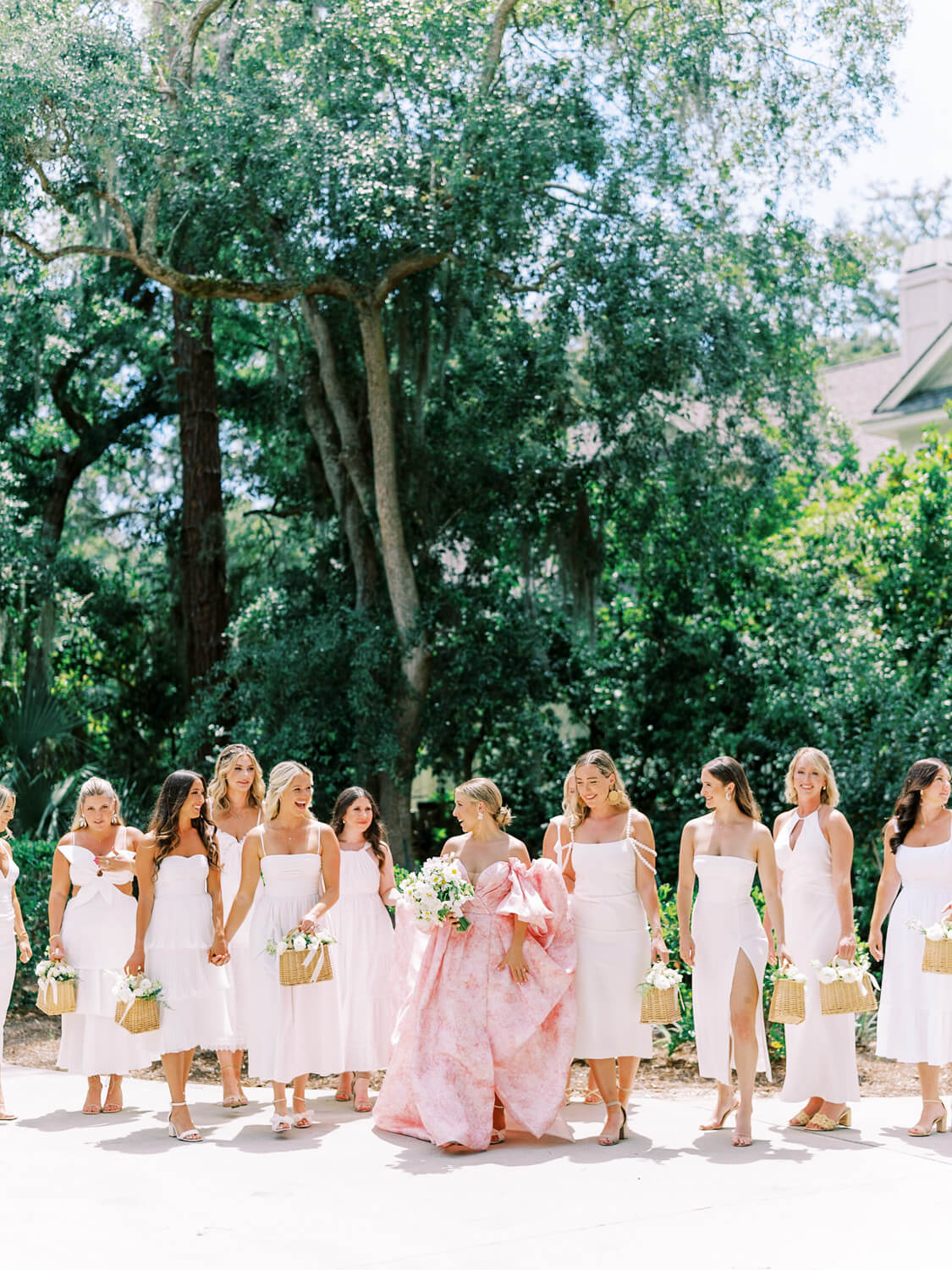 pink wedding dress and white bridesmaids with flower baskets