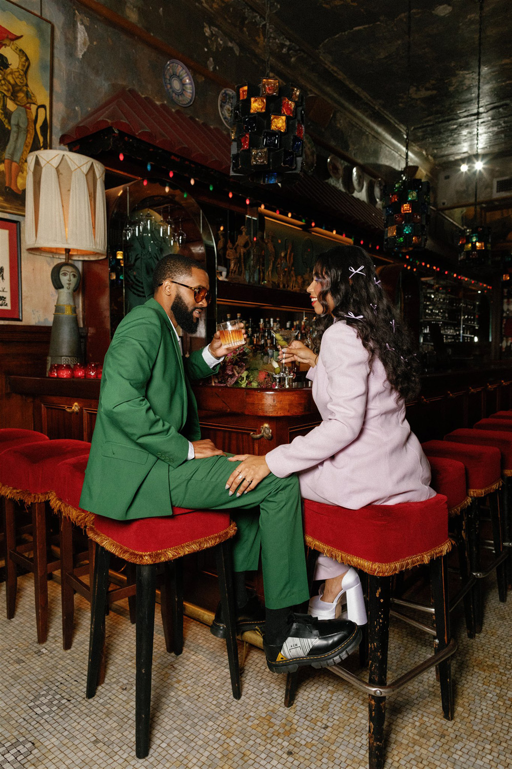 elopement portraits at Hotel Chelsea bar, with green and lavender suits