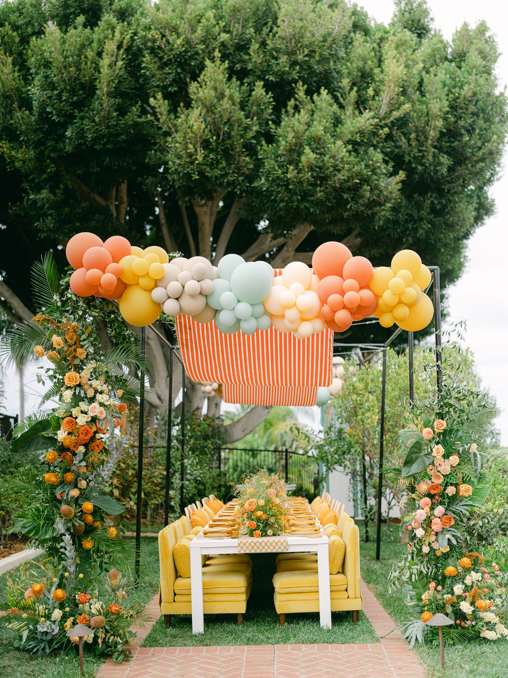 balloon and floral arch over table for 1st birthday party theme