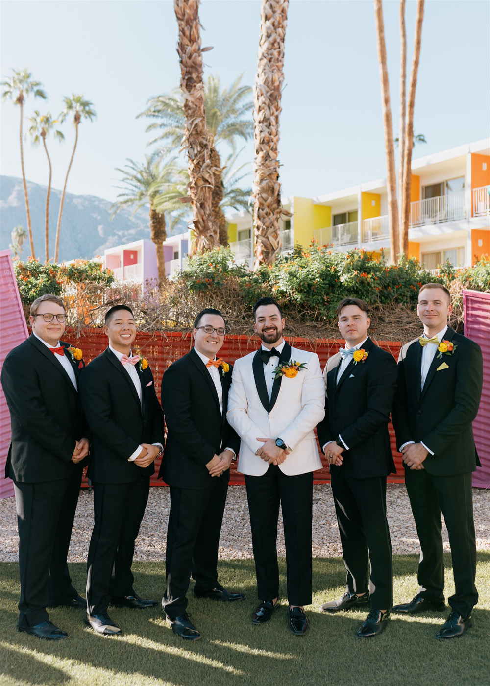 groom in white tux at The Saguaro wedding