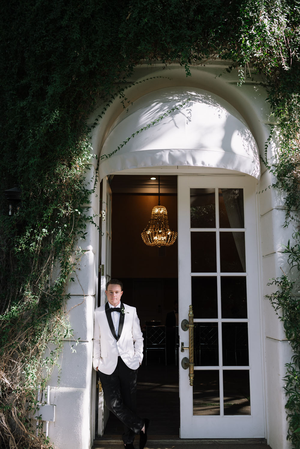 Groom in white tux jacket at Parker Palm Springs hotel
