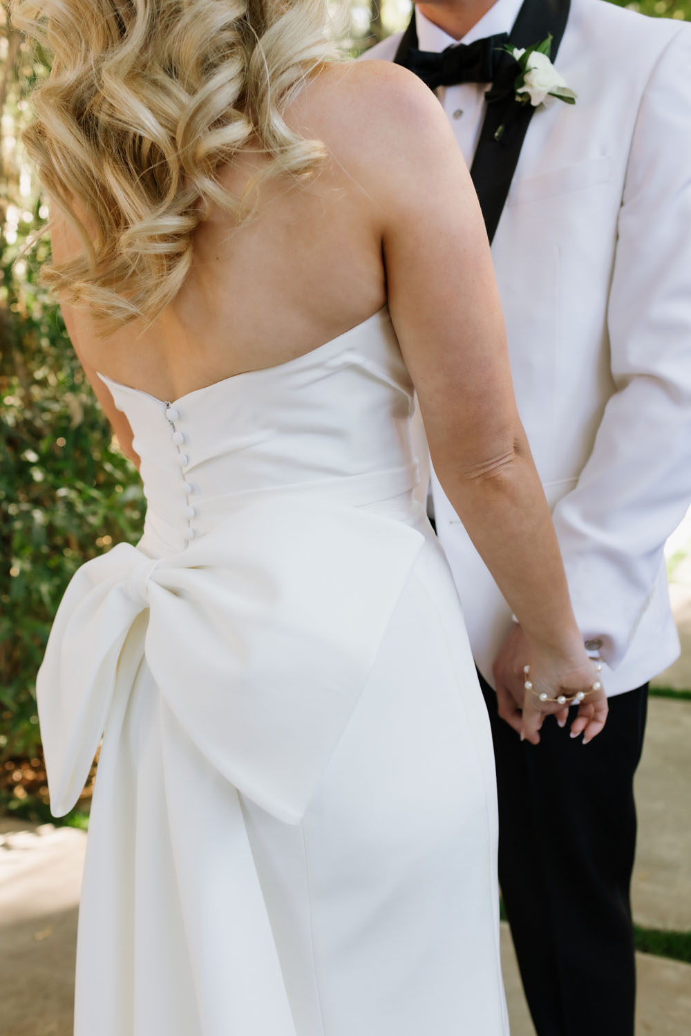 bride wearing bow back wedding dress