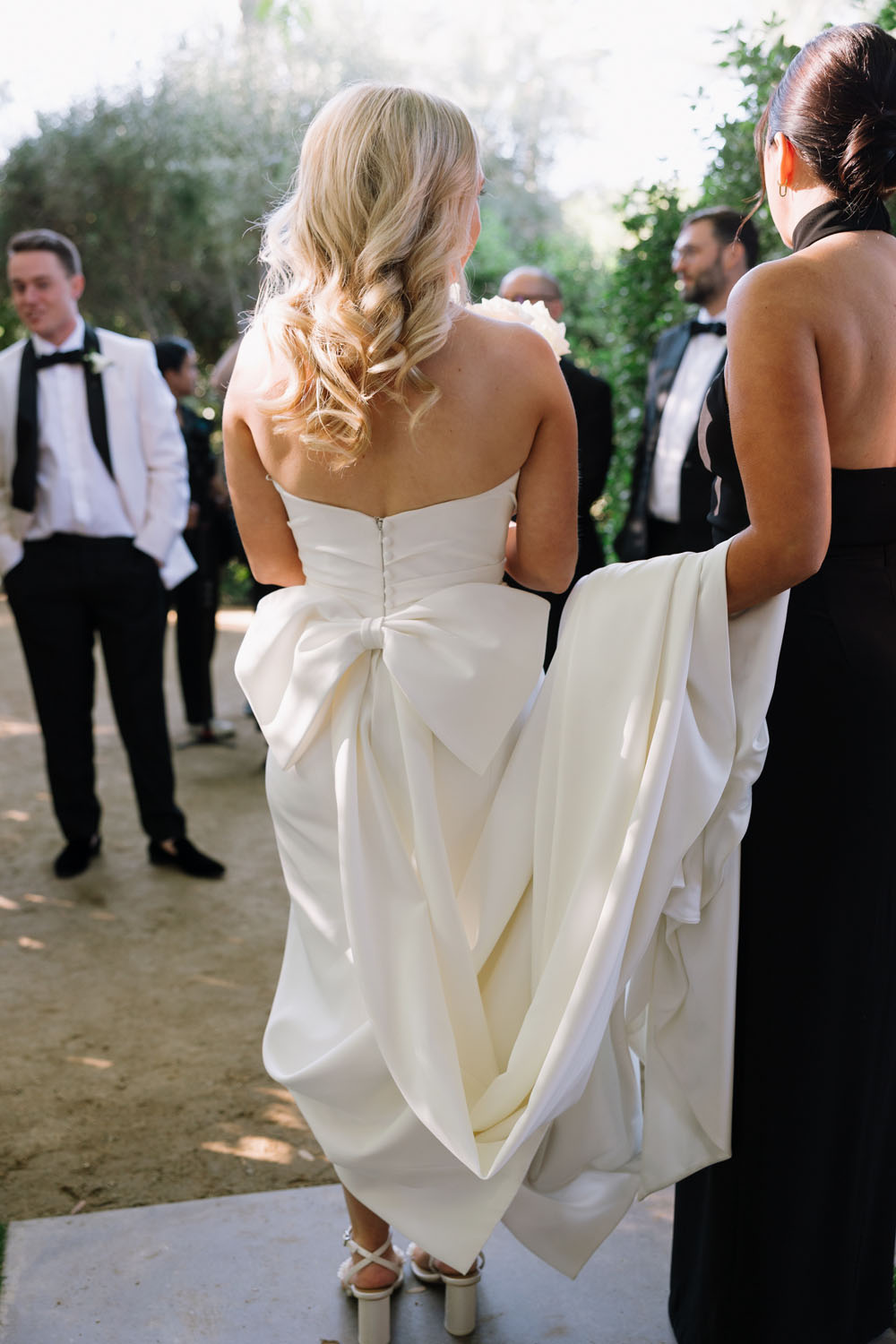 bride wearing wedding dress with oversize bow back
