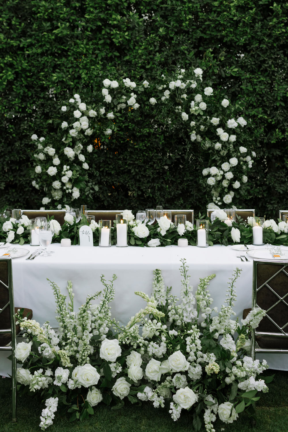 white rose floral arch over head table at Parker Palm Springs wedding