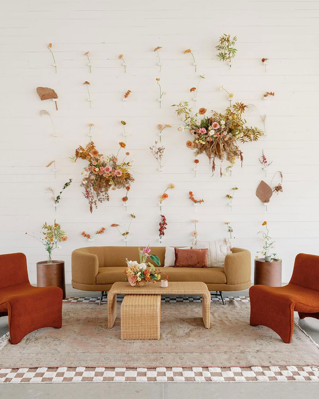 Modern lounge area and flower wall at wedding