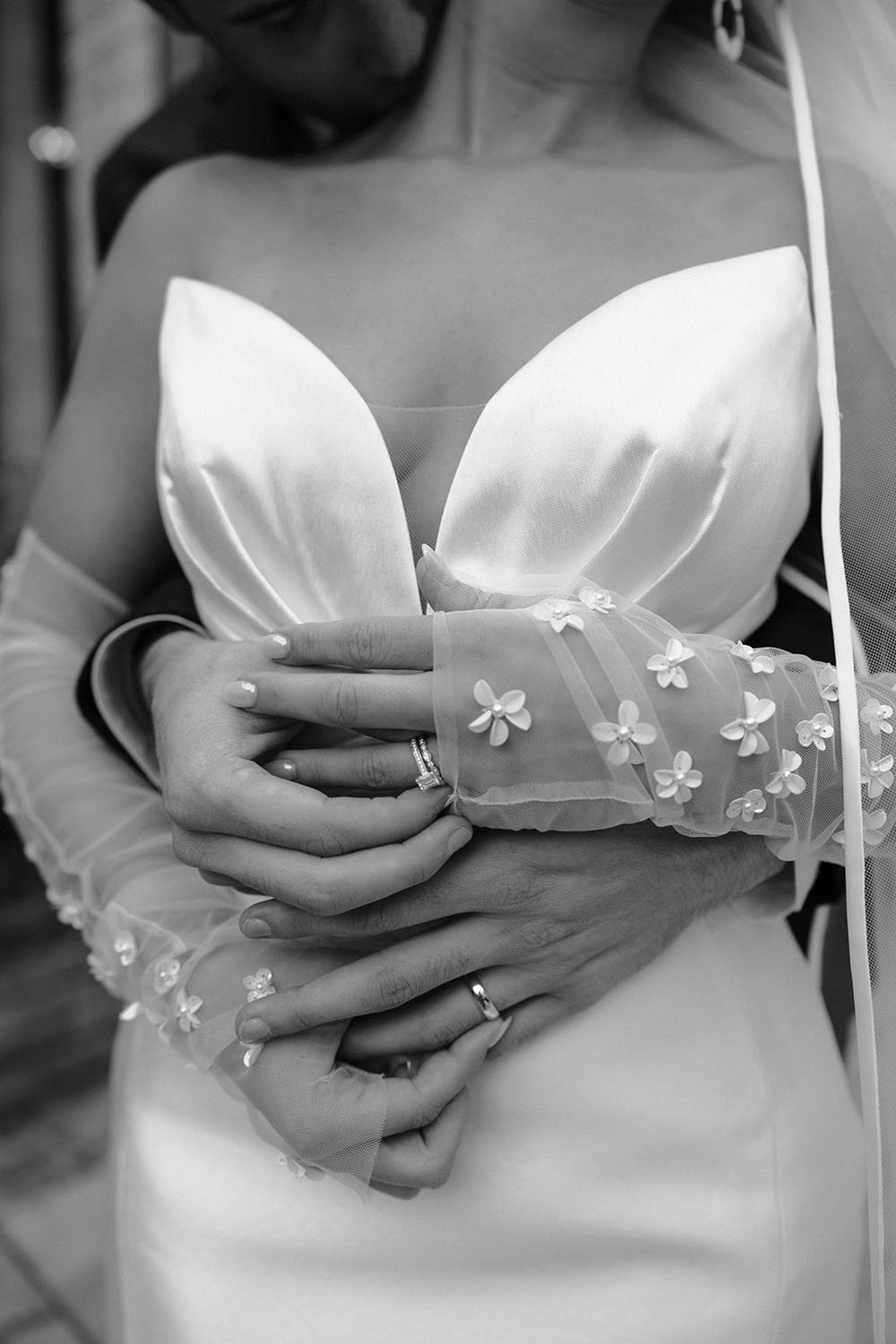 close up bridal portrait with pronovias wedding dress and flower embellished bridal gloves