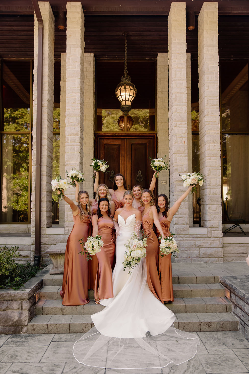 bridesmaids wearing rust satin dresses