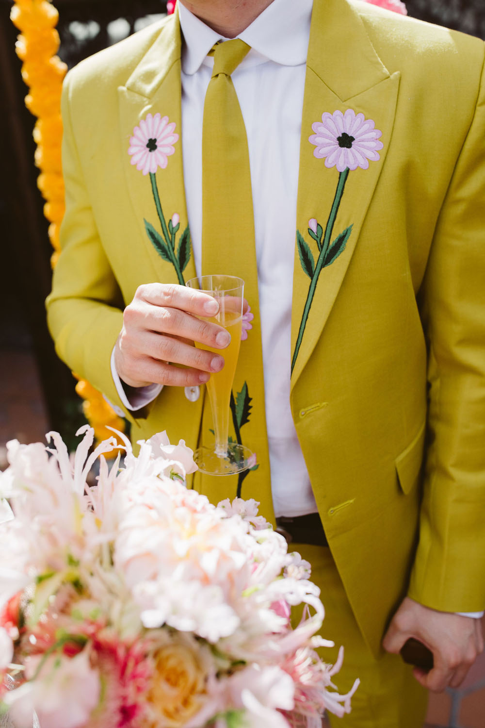 yellow grooms suit with floral embroidery