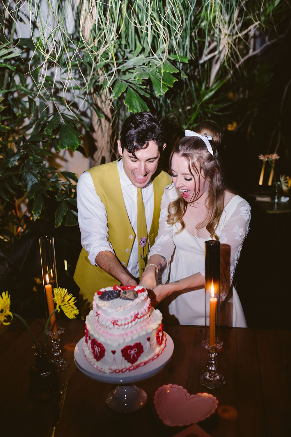 heart cake cutting at 1960s themed retro wedding
