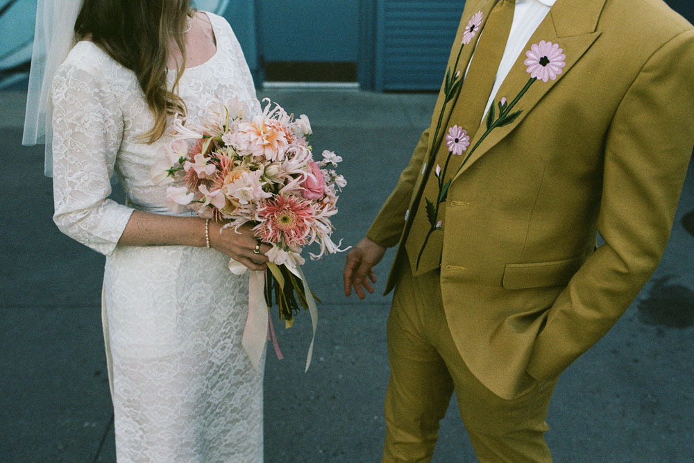 retro grooms suit and daisy bouquet