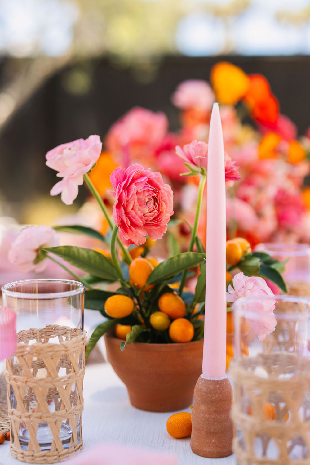 Pink taper candles and floral centerpiece for Cinco de Mayo party from Beijos Events