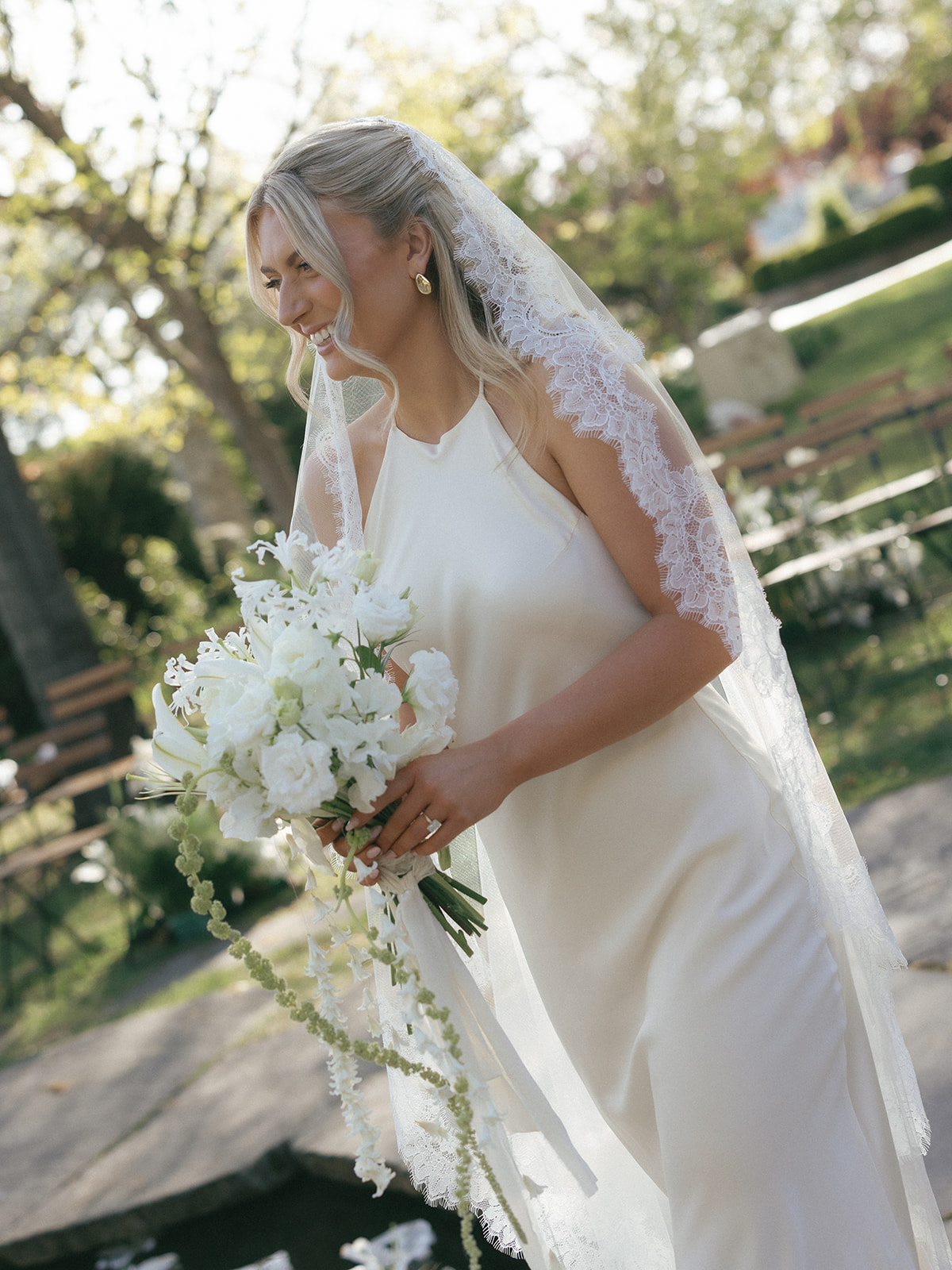 Overflowing floral arrangement with lilies, sweet peas, and textural greens