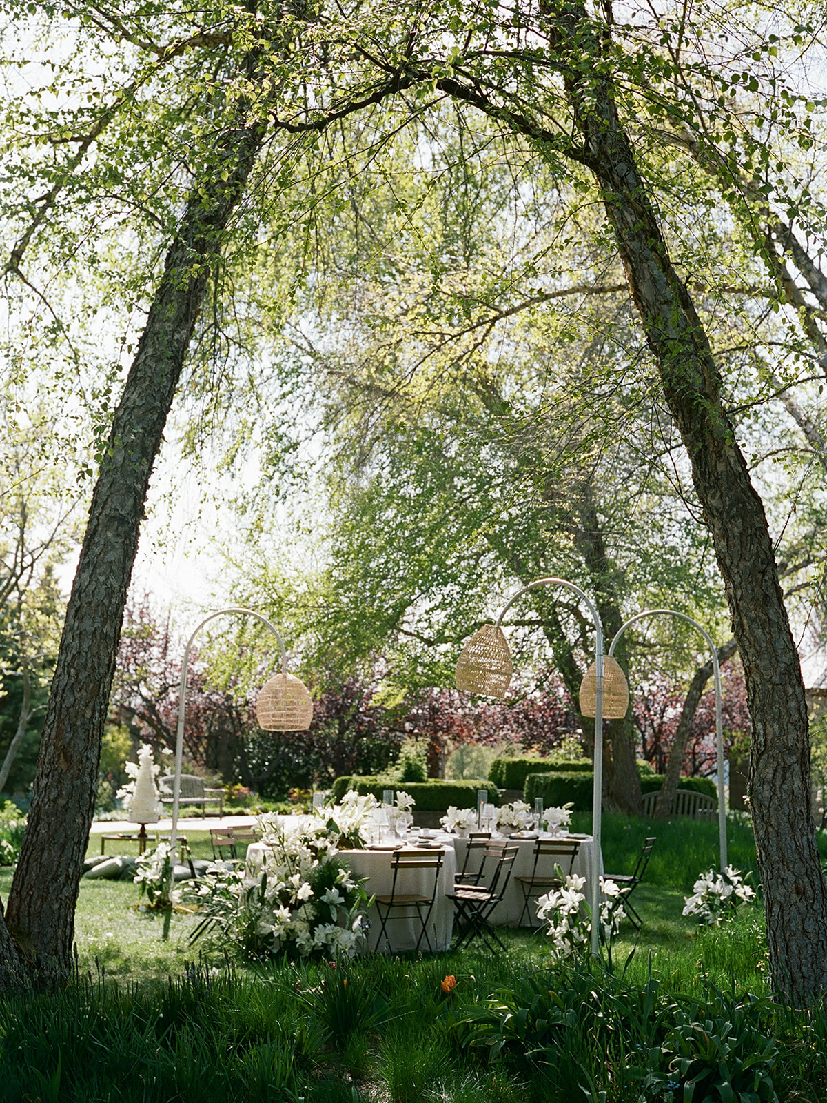 elegant garden wedding tablescape with linen tablecloths, vintage lamps, and spring florals