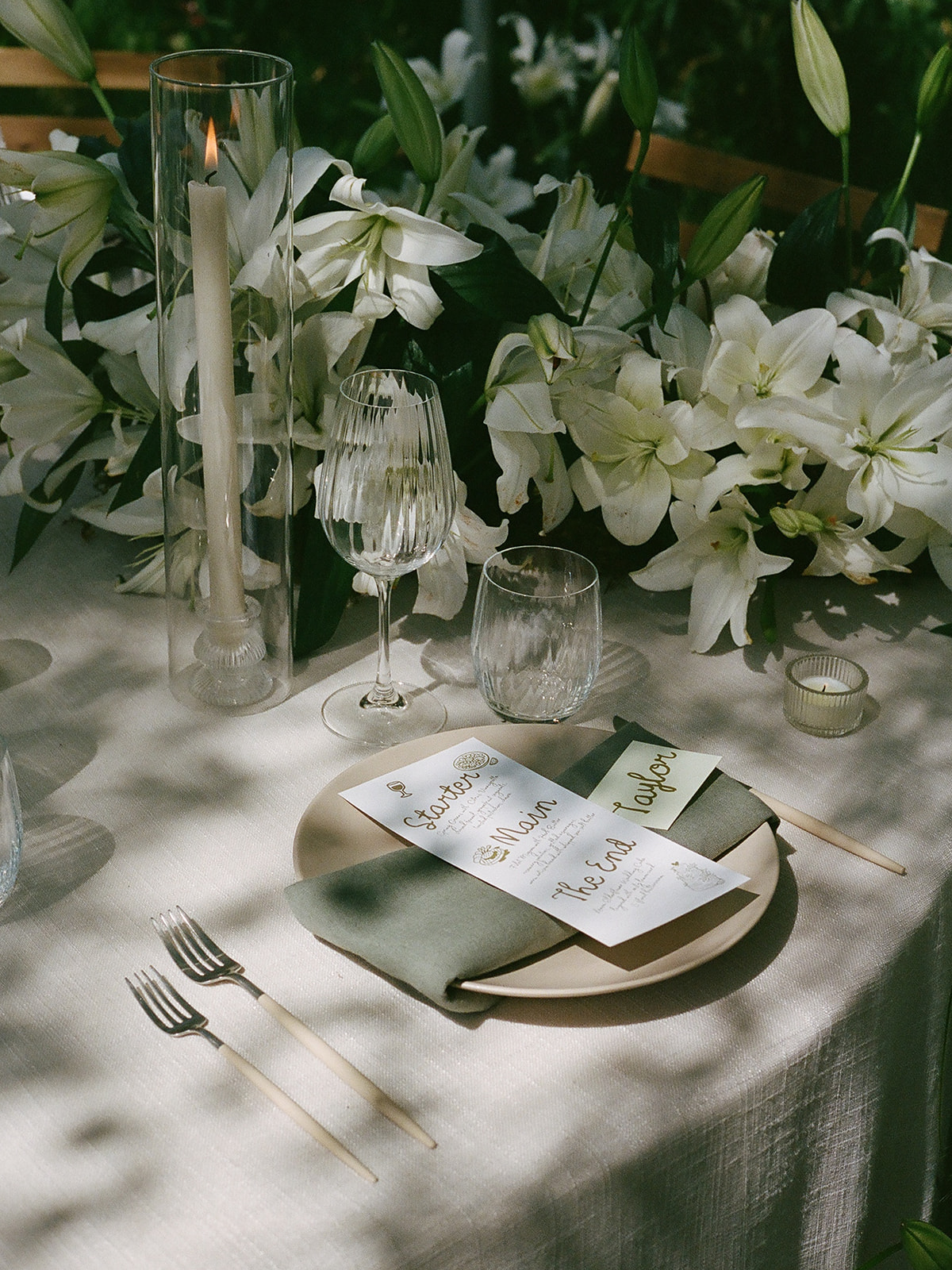 elegant garden wedding tablescape with linen tablecloths, vintage lamps, and spring florals