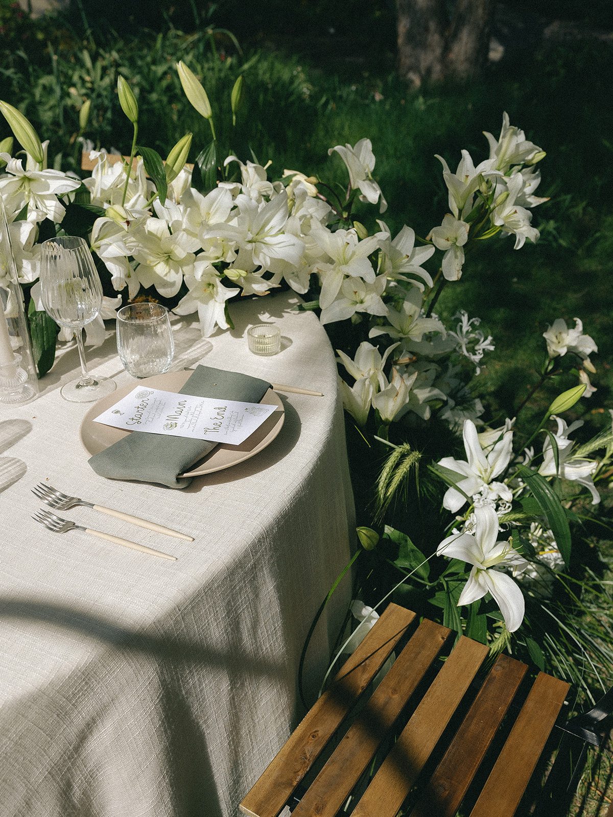 Close-up of white lilies and blush seasonal blooms in garden-inspired centerpiece