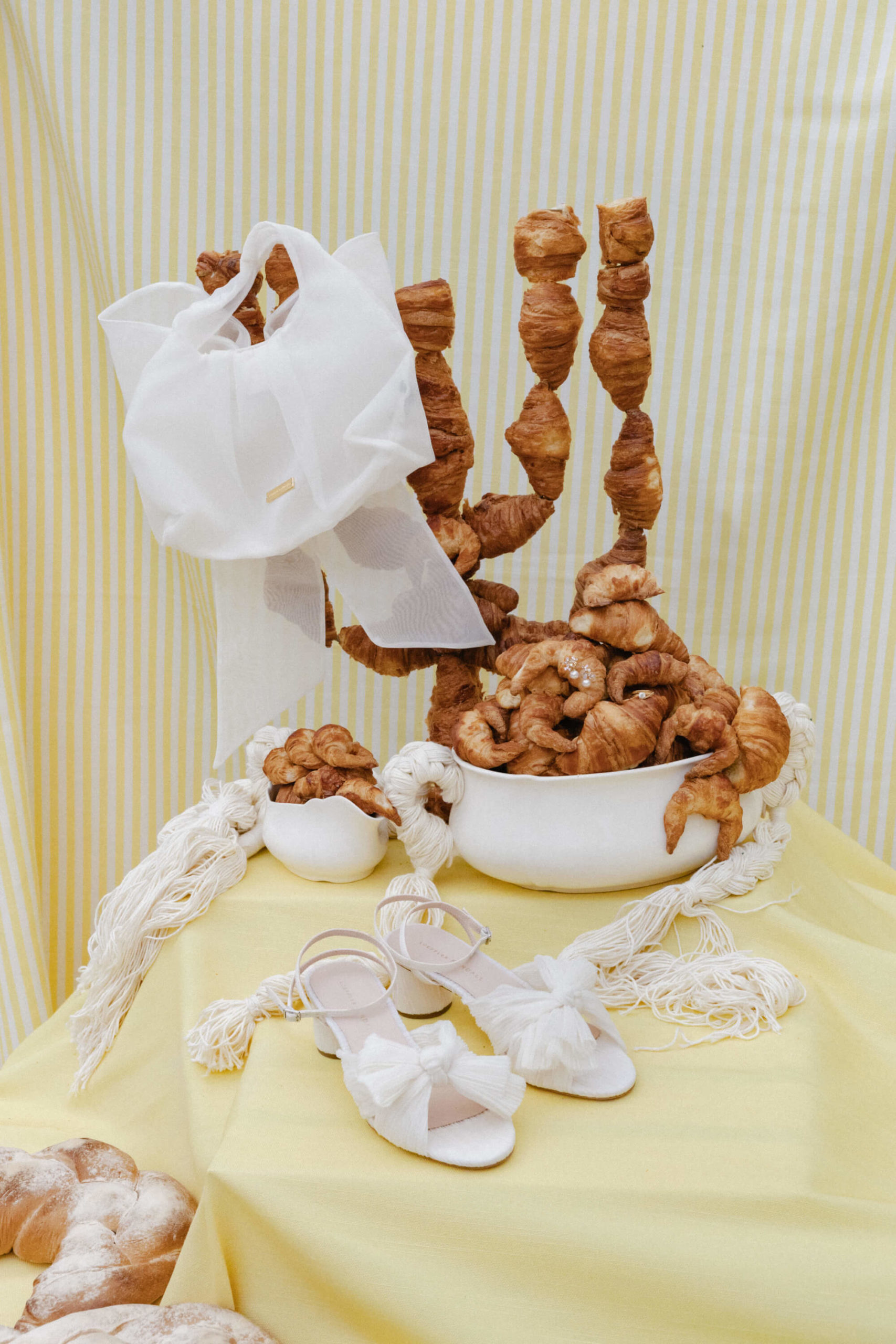 Croissant and brioche sculptures styled as wedding décor at a French château wedding reception near Versailles.