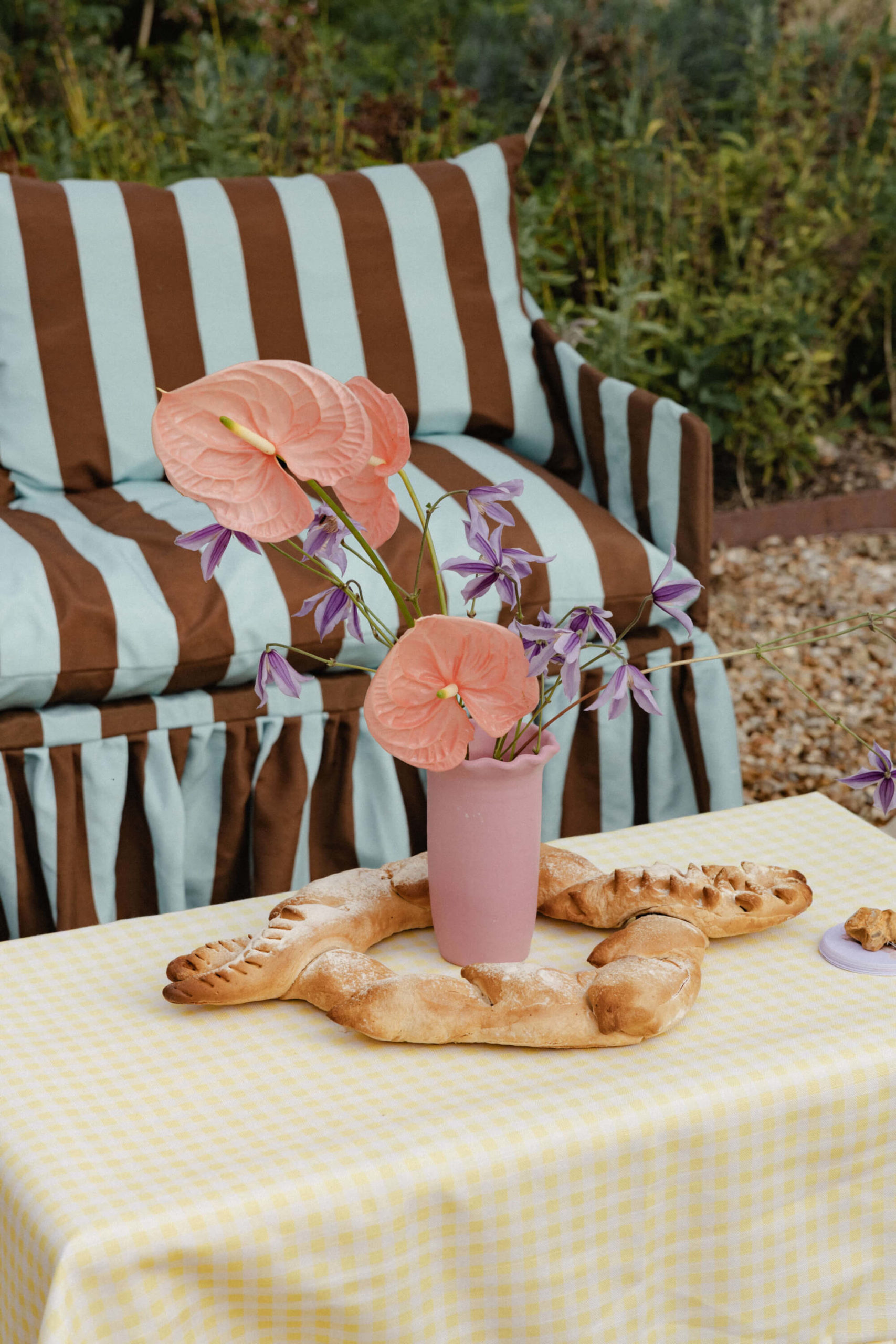 Unique wedding centerpiece combining colorful flowers with sculptural bread and croissants at a French château reception near Versailles