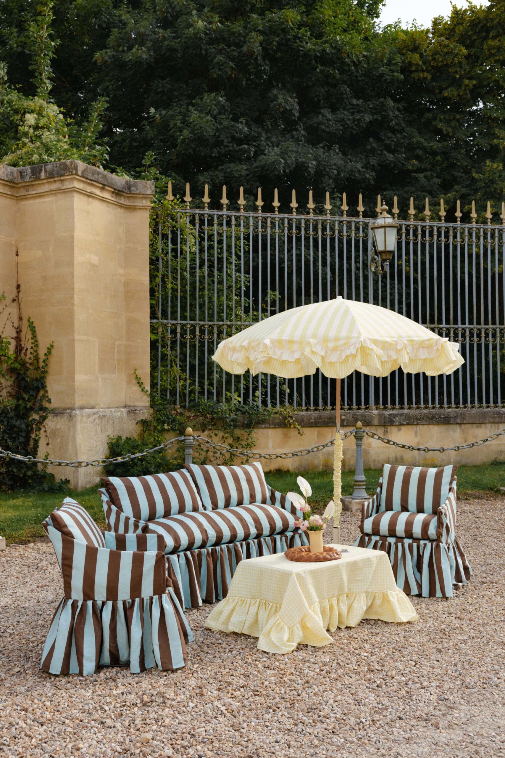 Wedding lounge setup with ruffled fabric furniture and couture-inspired textiles at a luxury destination wedding near Versailles.