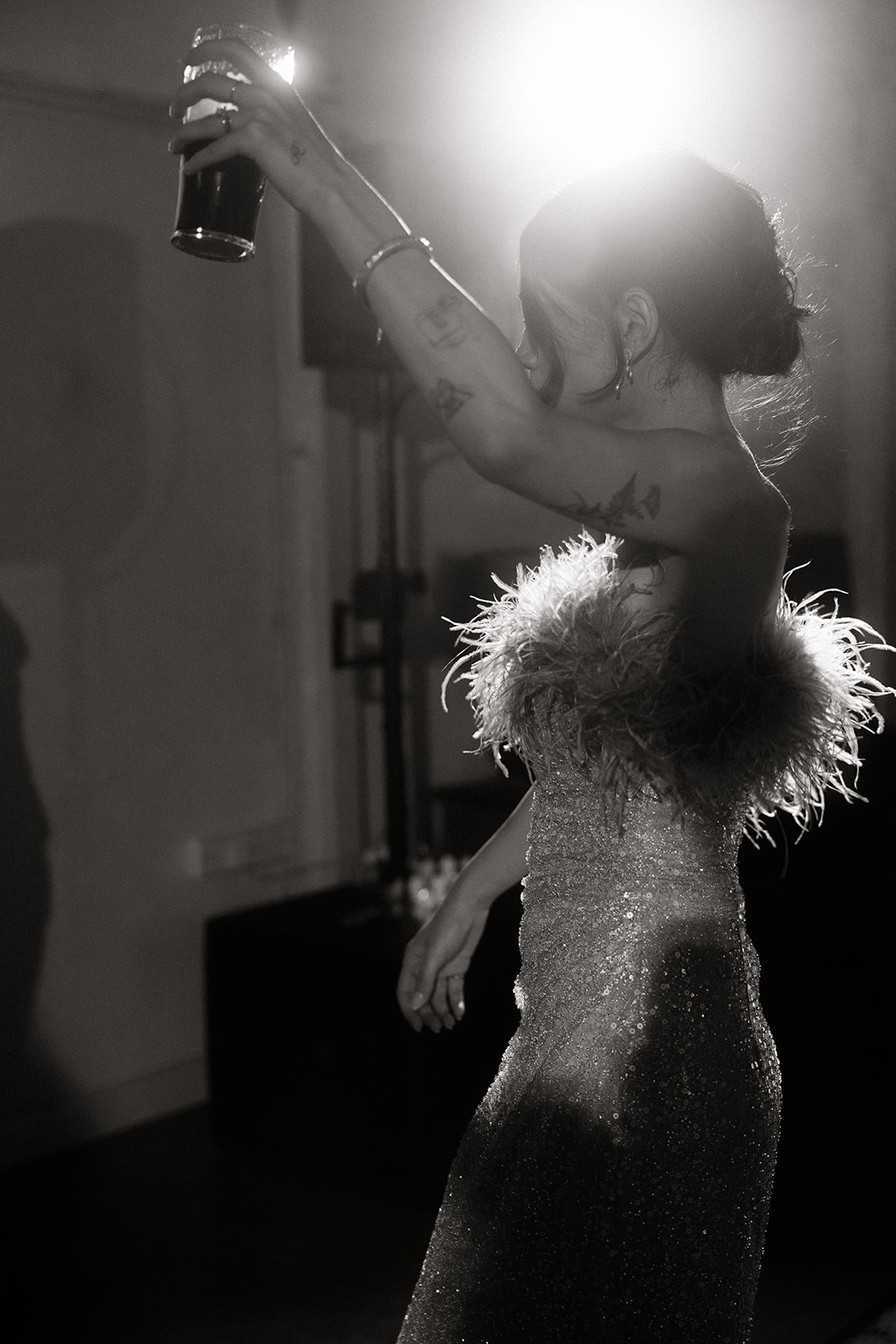 bride in chic feather reception dress