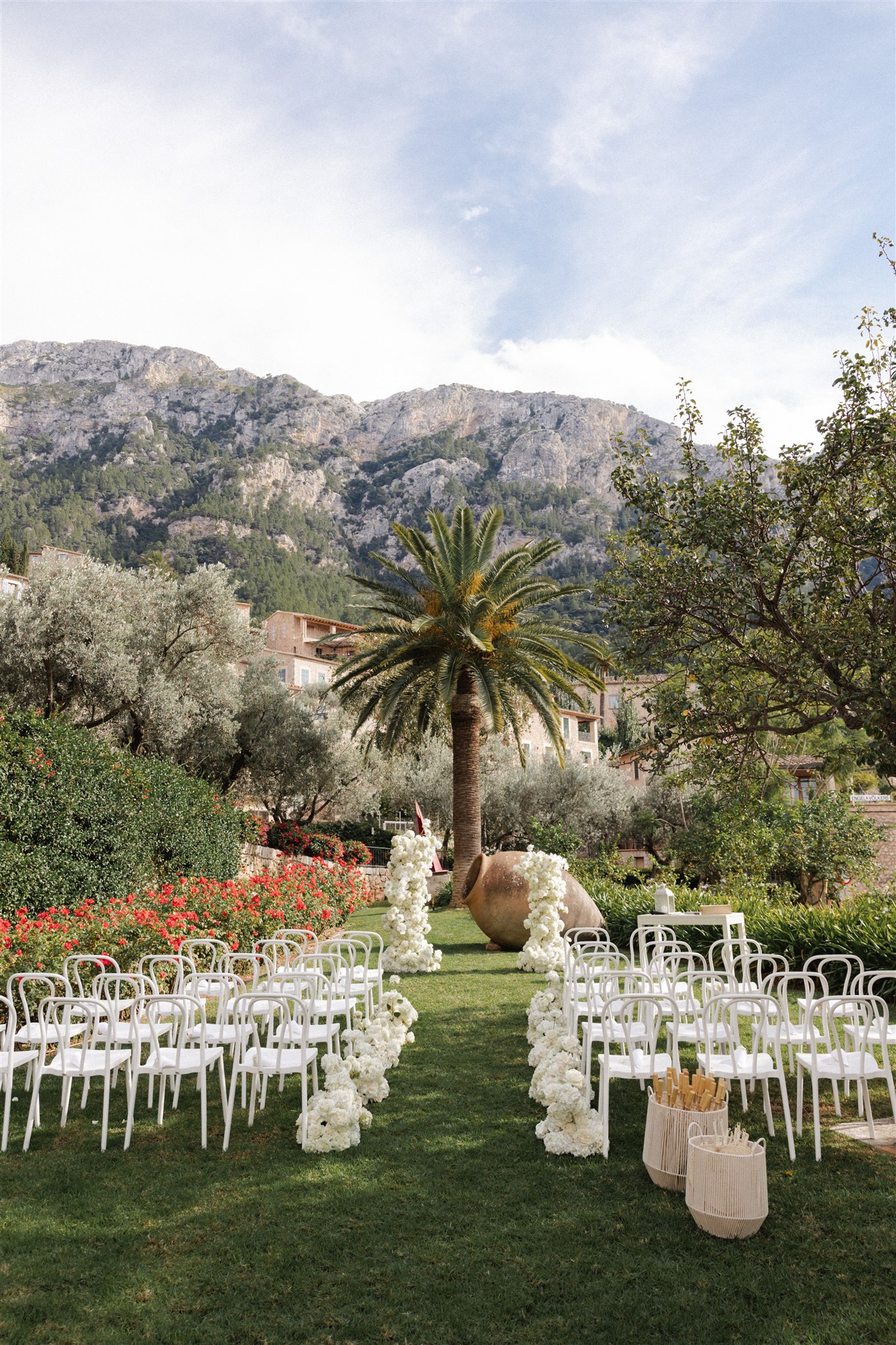A panoramic view of La Residencia in Deià, Mallorca set among lush mountains for a destination wedding.