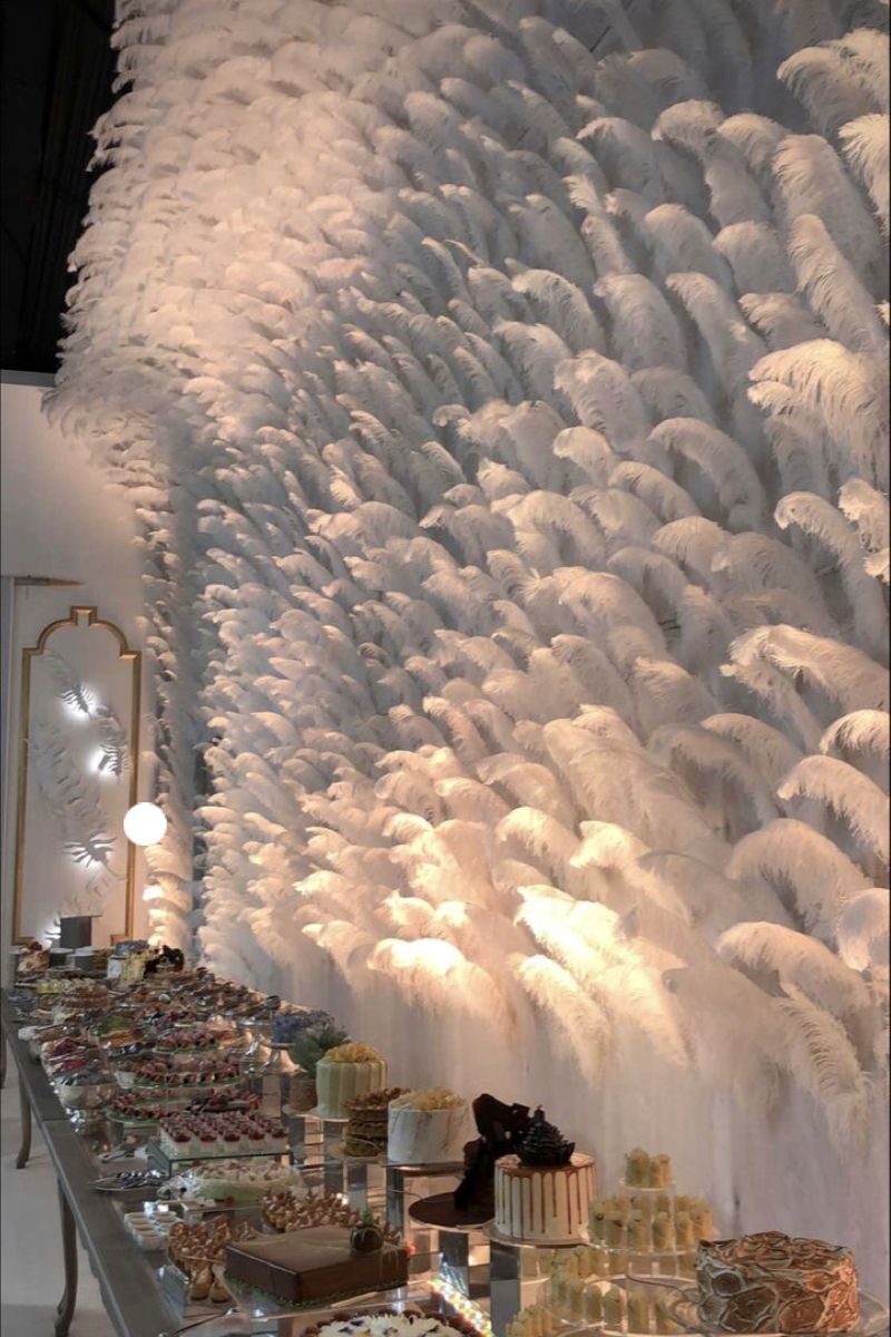 white wedding reception with feather decor