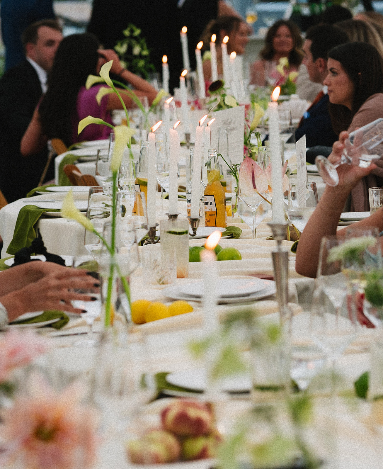 Romantic wedding reception at a private Vermont estate featuring vintage tables, classic florals, and an untraditional layout