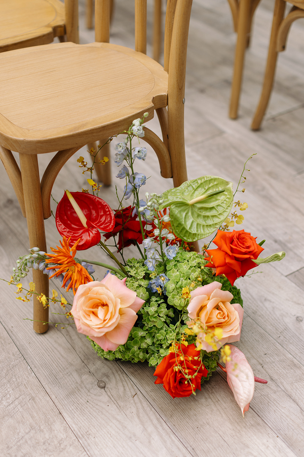 Bright citrus and berry toned ceremony flowers by BouK Design Co. at a colorful Chicago wedding ceremony