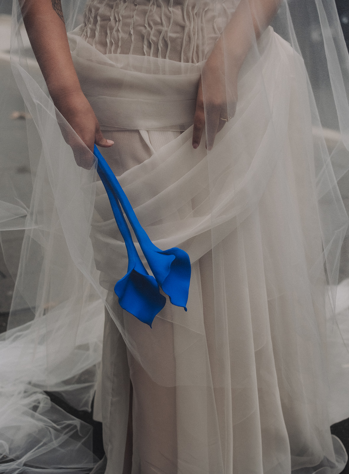 Bride holding a Yves Klein blue ceramic bouquet