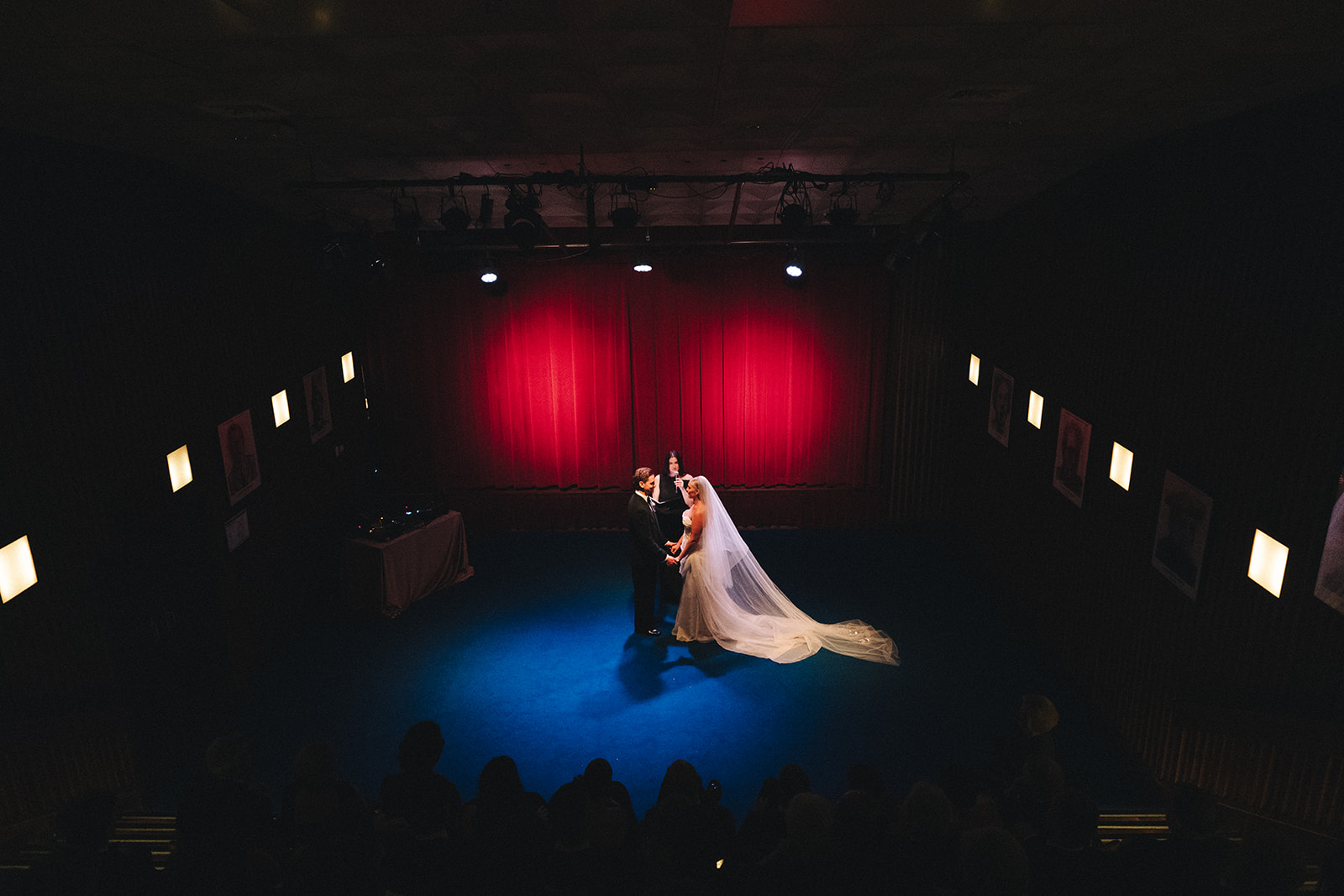 Theatre wedding ceremony at Hubert Sydney with red velvet backdrop and blue carpet aisle