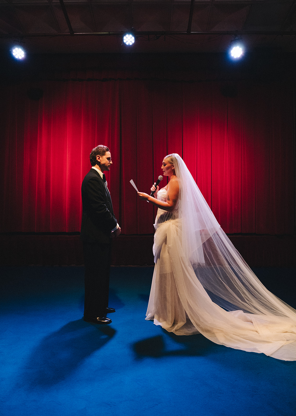 Intimate theatre wedding ceremony at Hubert Sydney with red velvet backdrop and blue carpet aisle
