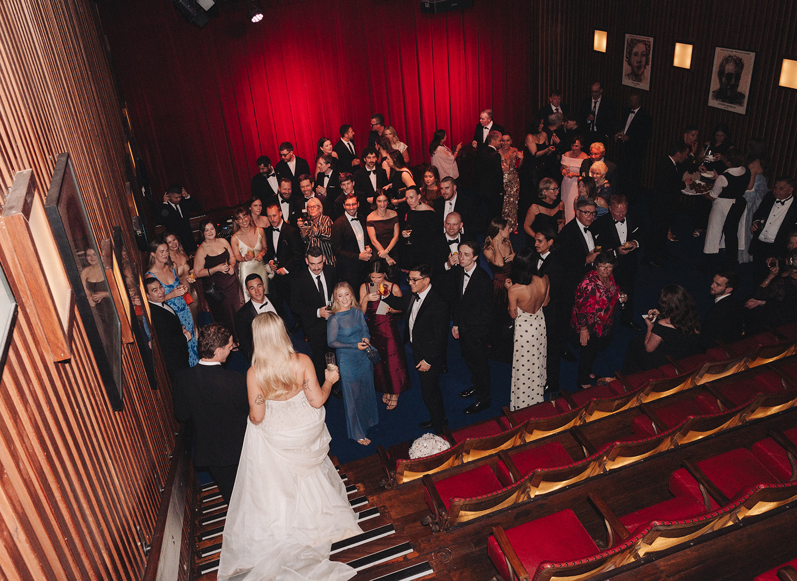 Intimate theatre wedding ceremony at Hubert Sydney with red velvet backdrop and blue carpet aisle