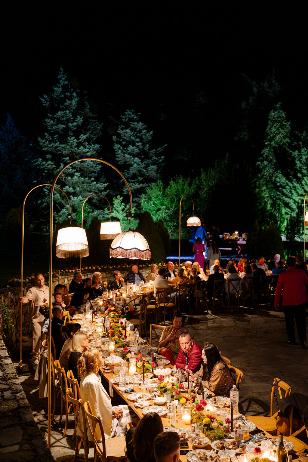 Candlelit outdoor wedding dinner surrounded by trees on Mount Olympus