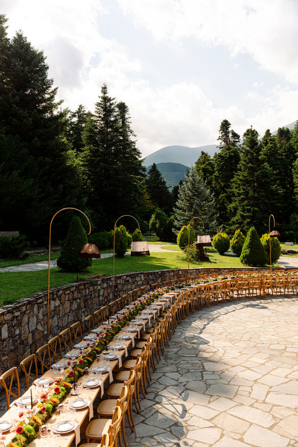 long outdoor dinner table beneath the trees at a Mount Olympus wedding