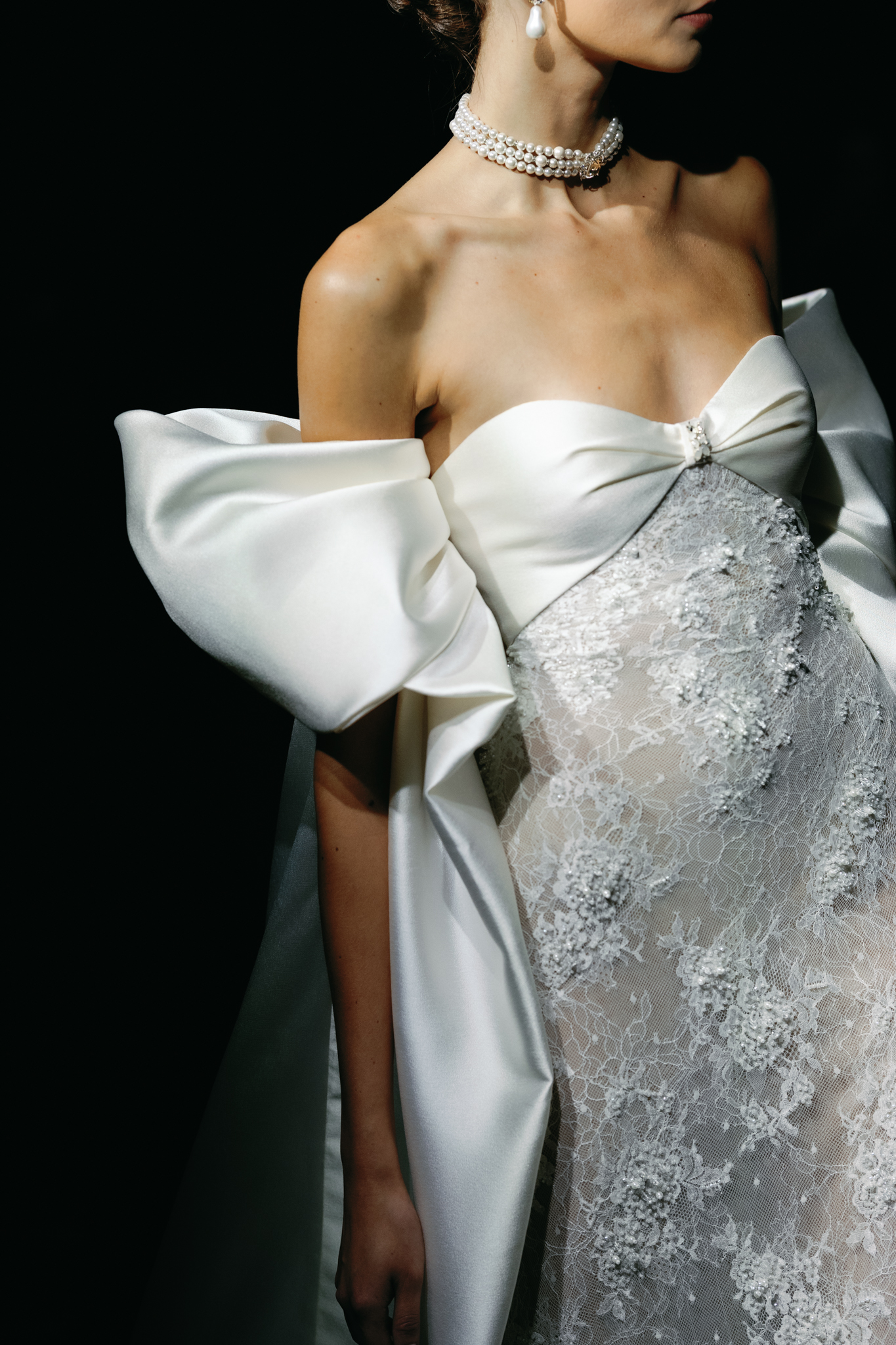 Close-up of Alon Livné bridal gown featuring oversized sculptural satin bows and intricate embellishments