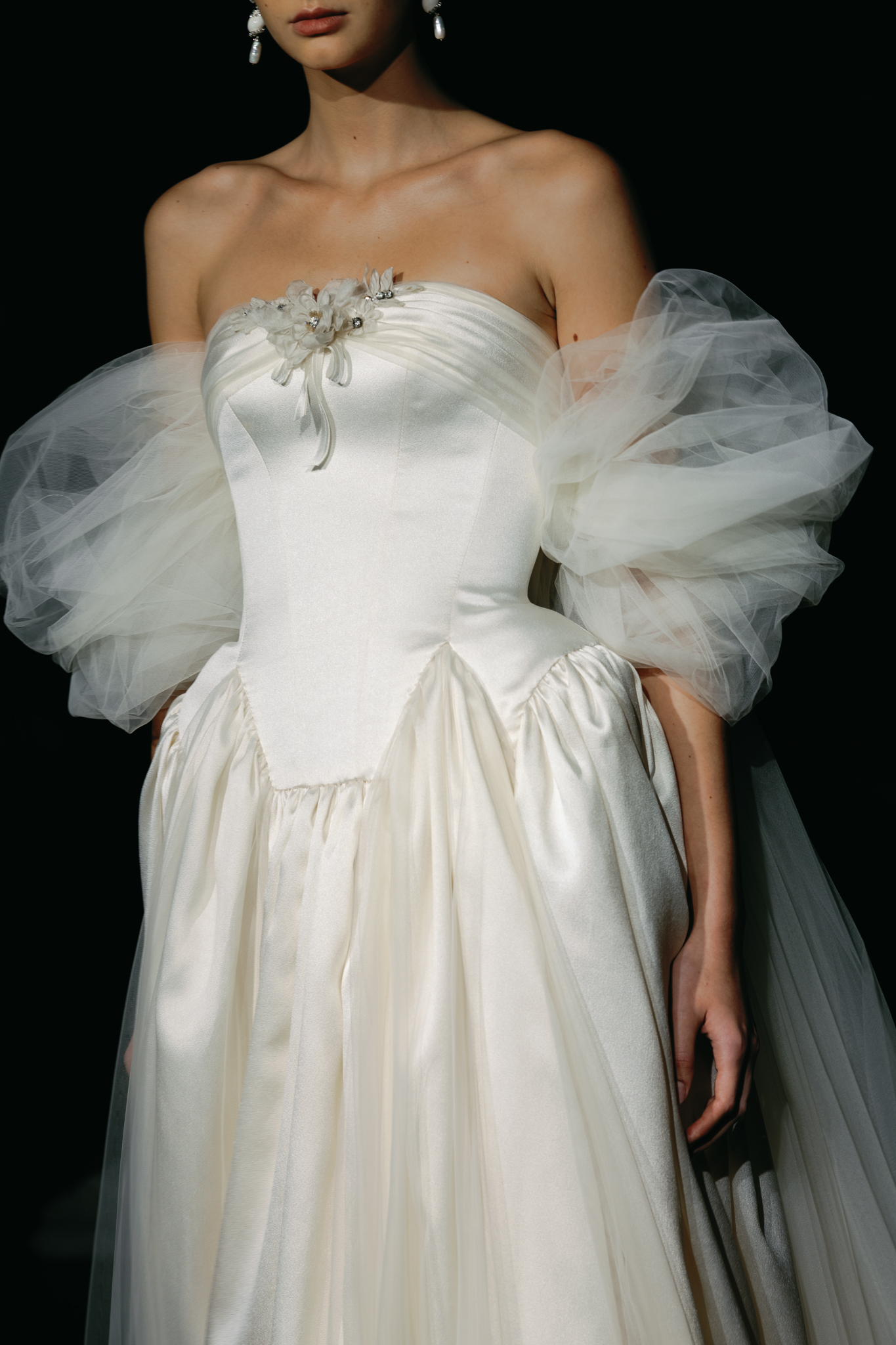 Strapless ivory wedding gown with oversized sculptural tulle sleeves and gathered satin bodice