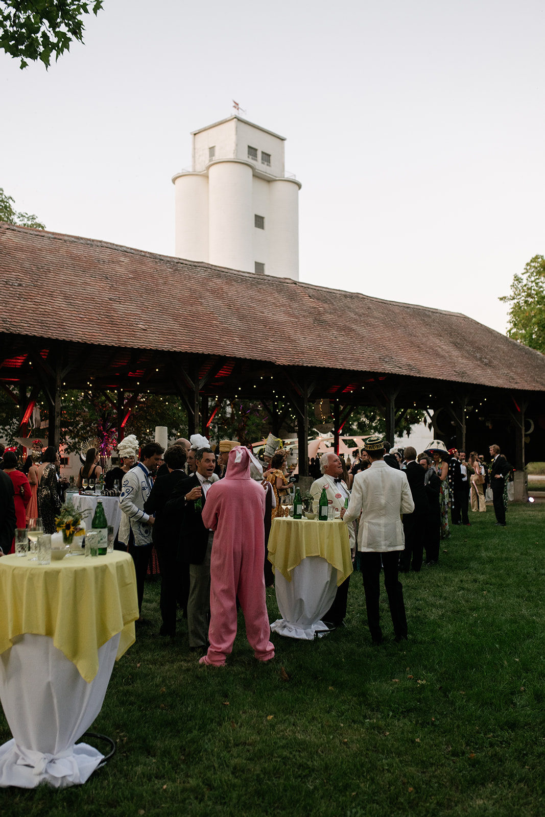 Wedding guests gathering outside a rustic barn at Gutshof Alt-Prerau in the Austrian countryside.